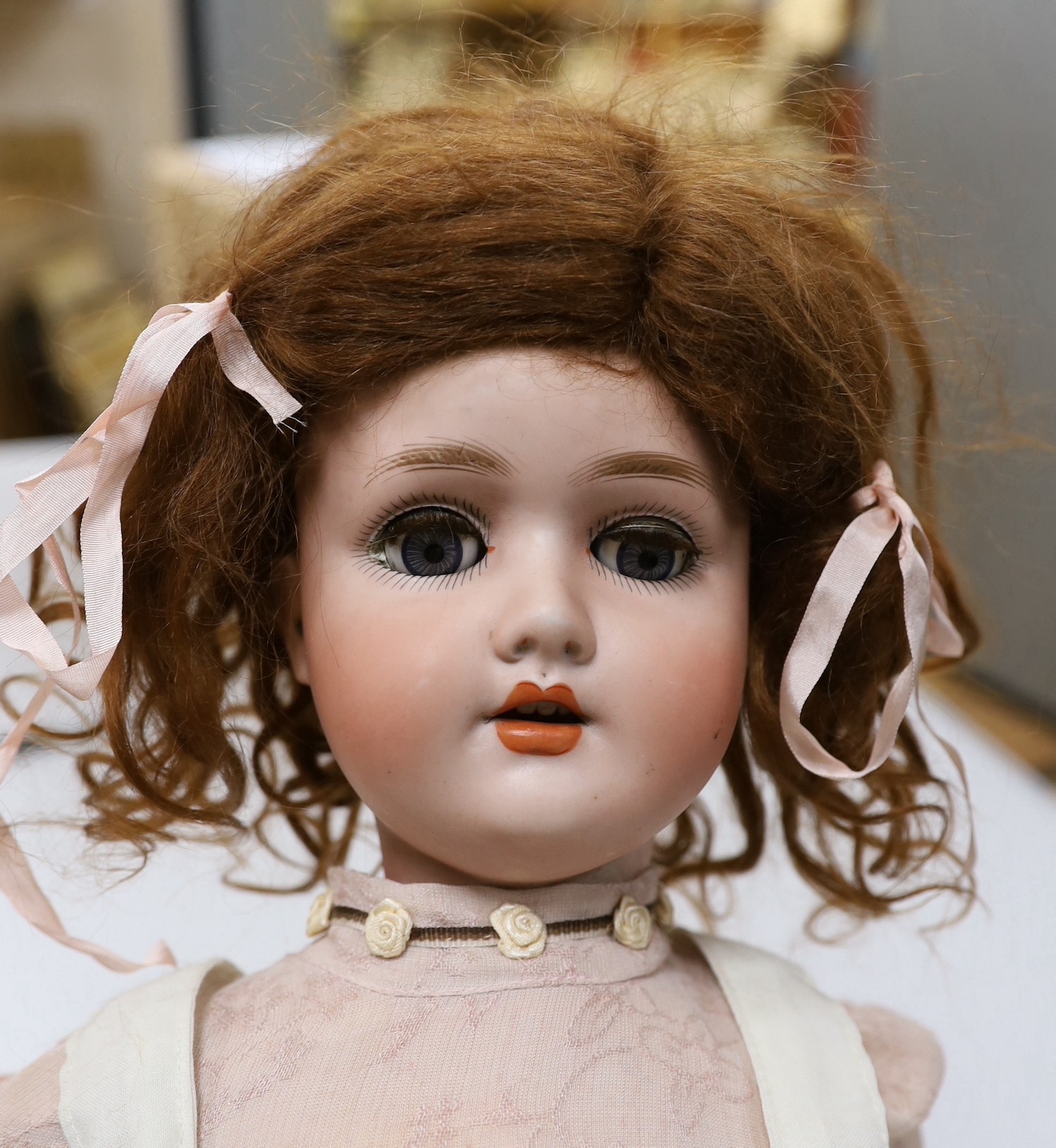 An early 20th century Schoennau & Hoffmeister bisque headed doll, 64cm